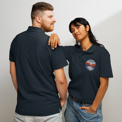 Unisex premium Polo Shirt navy mit rundem Brustemblem